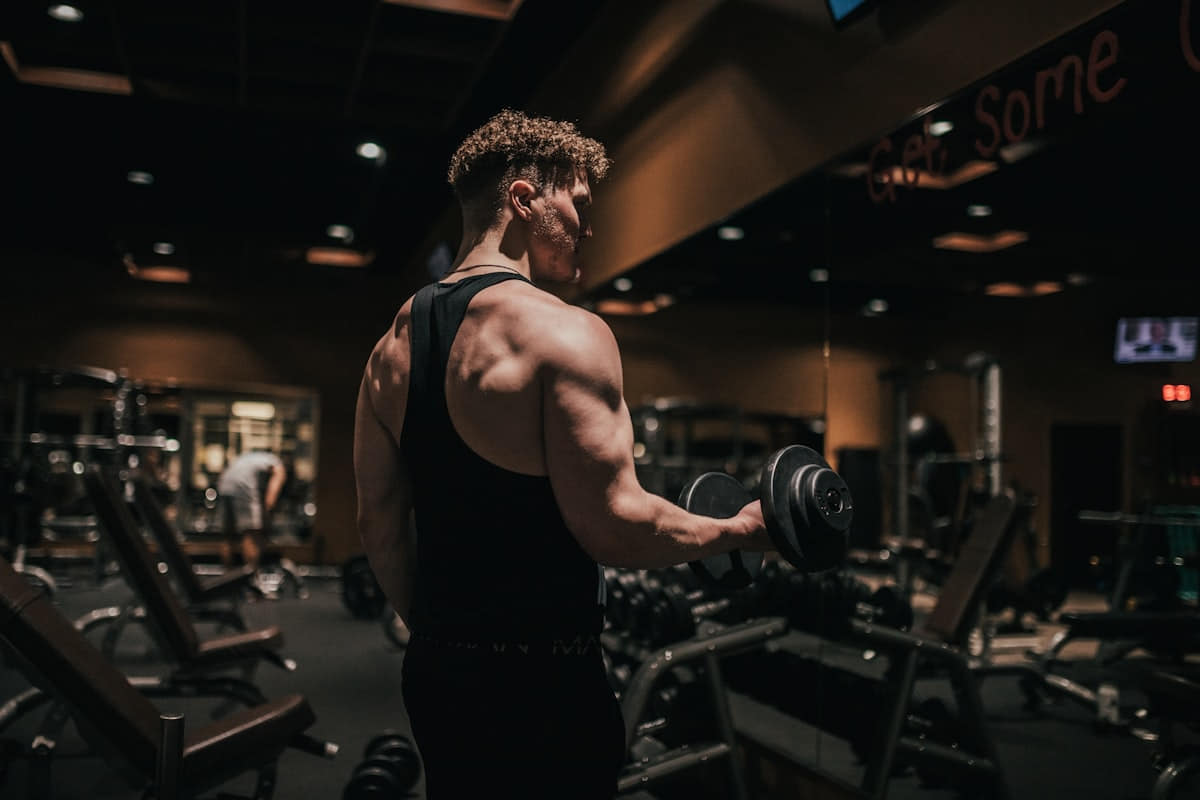 Athlete performing a dumbbell bicep curl in the gym